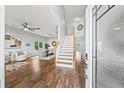 Bright entryway with wood floors, staircase, and open view of living and dining areas at 25521 Bruford Blvd, Land O Lakes, FL 34639