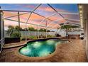Inviting backyard pool with brick pavers, a screen enclosure and a relaxing hot tub at 2814 Duncan Tree Cir, Valrico, FL 33594