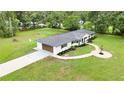Aerial shot of a beautiful home with an attached garage and well-maintained landscaping at 2933 Stearns Rd, Valrico, FL 33596