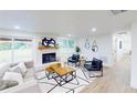 Bright living room with a brick fireplace, modern furniture, and hardwood floors at 2933 Stearns Rd, Valrico, FL 33596