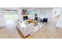Modern living room with a fireplace, stylish decor, and lots of natural light at 2933 Stearns Rd, Valrico, FL 33596