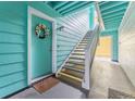 Exterior view of apartment entrance with blue siding and stairs leading to upper units at 3002 W Cleveland St # D4, Tampa, FL 33609
