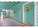 Apartment entrance with blue siding and a welcoming wreath on the door at 3002 W Cleveland St # D4, Tampa, FL 33609