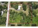 Aerial view of the property and neighborhood with mature trees and well maintained lawn at 3203 21St Se Ave, Ruskin, FL 33570