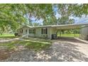 Well-maintained home with a covered parking area, gravel driveway and manicured landscaping at 3203 21St Se Ave, Ruskin, FL 33570