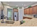 Well-equipped kitchen featuring stainless steel appliances, granite countertops, and ample cabinet space at 3212 E Merrin Rd, Plant City, FL 33567