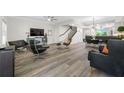 Spacious living room with modern decor, hardwood floors, staircase, and a connecting view into the dining area at 340 1St N St # I, St Petersburg, FL 33701