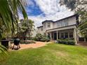 Spacious backyard featuring a sparkling pool, lush greenery, and an outdoor grilling area at 4313 W Vasconia St, Tampa, FL 33629