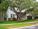 Charming home with lush landscaping, mature trees, and a well-manicured lawn at 4313 W Vasconia St, Tampa, FL 33629