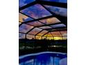 Relaxing screened-in pool area with a beautiful sunset view, perfect for evening enjoyment at 5103 98Th E Ave, Parrish, FL 34219