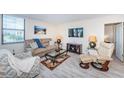 An inviting living room with comfortable seating, stylish decor, and bright natural light from the windows at 6145 Sun Blvd # 404, St Petersburg, FL 33715