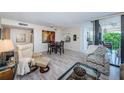 A spacious living room with light-colored floors, modern furnishings, and a glass-enclosed balcony at 6145 Sun Blvd # 404, St Petersburg, FL 33715