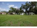 Expansive backyard with multiple sheds and plenty of green space at 7240 Ottley St, Zephyrhills, FL 33541