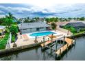Gorgeous aerial view of a home on the water with a large pool and private boat dock at 913 Spindle Palm Way, Apollo Beach, FL 33572