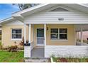 Welcoming front porch with brick accents, a storm door, and well-maintained landscaping at 963 27Th S Ave, St Petersburg, FL 33705