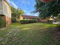 A single-story home with a green lawn and mature trees offering shade and curb appeal at 1011 Mallow Way, Brandon, FL 33510