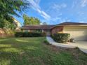 Attractive single-story home with brick facade, green lawn, and well-maintained landscaping at 1011 Mallow Way, Brandon, FL 33510