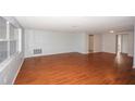Bright living room featuring gleaming hardwood floors and neutral paint at 10740 Oldham Rd, Port Richey, FL 34668