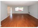 Inviting living room with large window, showcasing natural light and stylish flooring at 10740 Oldham Rd, Port Richey, FL 34668