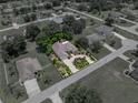 Aerial view of a lovely home with mature trees, lush landscaping and neatly defined property lines at 11530 Arlhuna Way, Dade City, FL 33525