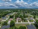 Aerial view showcases this home's large lot, mature trees, and attractive landscaping in established neighborhood at 11530 Arlhuna Way, Dade City, FL 33525