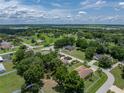 Aerial view showing the lovely landscaping, mature trees and location within this quiet residential neighborhood at 11530 Arlhuna Way, Dade City, FL 33525