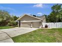 Spacious three-car garage and well-maintained lawn enhance this beautiful home's curb appeal at 12219 Steppingstone Blvd, Tampa, FL 33635