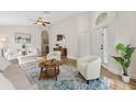 Bright living room with hardwood floors, vaulted ceiling, and stylish furniture at 12229 Coldstream Ln, Tampa, FL 33626
