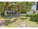 Cozy home featuring an expansive backyard shaded by a mature oak tree at 1235 Bass Blvd, Dunedin, FL 34698