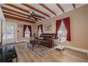 Inviting living room with exposed wood beams, wood flooring, and plentiful light at 1235 Bass Blvd, Dunedin, FL 34698