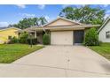 Well-maintained single-story home with large driveway and tidy front landscaping at 13127 Topflite Ct, Hudson, FL 34669