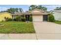 Inviting single-story home features a well-kept lawn and a two-car garage at 13127 Topflite Ct, Hudson, FL 34669
