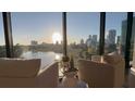 Cozy living room view showcases stunning sunrise views from the floor to ceiling windows of the surrounding cityscape at 132 Mirror Lake N Dr # 501, St Petersburg, FL 33701
