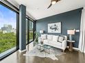 Stylish living room with modern decor, floor-to-ceiling windows offering great views, creating an inviting urban space at 132 Mirror Lake N Dr # 501, St Petersburg, FL 33701