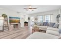 Bright living room with a ceiling fan, modern furnishings, and a large sectional sofa at 13306 Wildgrass Trl, Odessa, FL 33556