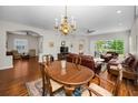 Spacious living room featuring wood floors, a dining area, and large windows at 1528 Riverdale Dr, Oldsmar, FL 34677