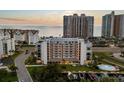 Stunning exterior view of a condo building with a waterfront pool and boat docks at 1581 Gulf Blvd # 403N, Clearwater Beach, FL 33767