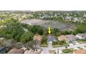 Aerial view of home showing surrounding homes, pond, and lush landscape at 1852 Longview Ln, Tarpon Springs, FL 34689