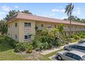 Charming condo building with well-manicured landscaping, inviting walkways, and ample parking at 2003 Greenbriar Blvd # 1, Clearwater, FL 33763