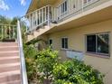 Close-up of the condo's exterior staircase, showcasing the architecture and surrounding greenery at 2003 Greenbriar Blvd # 1, Clearwater, FL 33763
