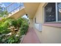 Outdoor patio area on the condo grounds, with seating and manicured hedges at 2003 Greenbriar Blvd # 1, Clearwater, FL 33763