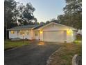 Charming single-story home featuring a two-car garage with updated lighting at 22365 Panorama St, Brooksville, FL 34601