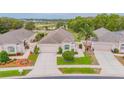 Aerial view of a single-story home with manicured lawn, landscaping, and a private driveway in a quiet community at 241 Royal Palm Way, Spring Hill, FL 34608