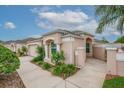 Single-story home featuring a two-car garage, manicured lawn, and tasteful landscaping at 241 Royal Palm Way, Spring Hill, FL 34608