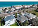 Aerial view of residences on a sunny day, with beach, palm trees, and street views at 2801 Gulf Blvd, Belleair Beach, FL 33786