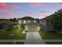 Charming two-story home with a well-maintained lawn, inviting curb appeal, and a tranquil evening sky at 30317 Rattana Ct, Wesley Chapel, FL 33545