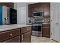Modern kitchen featuring stainless steel appliances, stylish backsplash, and granite countertops at 30317 Rattana Ct, Wesley Chapel, FL 33545