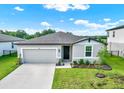 Beautiful single-story home with an attached garage, manicured lawn, and welcoming front entrance at 3146 Forrest Plum Ct, Zephyrhills, FL 33540