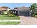 Charming home with well-manicured lawn, paver driveway, and neutral paint scheme at 3167 Forsythia Dr, Odessa, FL 33556