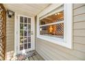 Inviting porch with a window, colorful welcome mat, and glass-paned door at 3320 Jackson N St, St Petersburg, FL 33704